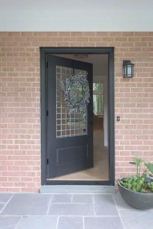 Open front door of home remodel project in Northern Virginia by Denny + Gardner
